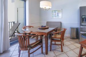 a dining room with a wooden table and chairs at Phoenix VI 61507 in Orange Beach