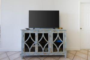a tv sitting on top of a wooden stand at Phoenix VI 61507 in Orange Beach +56 photos