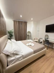 a bedroom with a bed and a desk and a television at NAVONA MORGAN suite in Rome