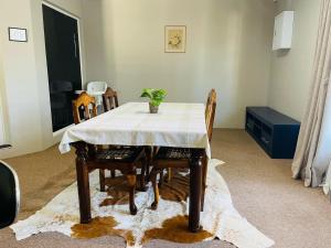 a dining room table with a white table cloth on it at Quiet Corner Guest House Kokstad in Kokstad