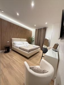 a bedroom with a bed and a couch and chairs at NAVONA MORGAN suite in Rome