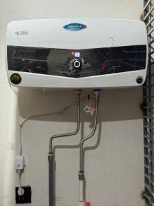 a washing machine is hanging on a wall at Double Delight-Two Single Beds, Private Entrance Available On Sharing Also in Karachi