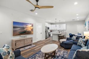 a living room with blue couches and a kitchen at New build in Old West #2 3 Bed 2 Bath Family Rental in Tampa