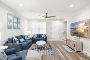 a living room with blue couches and a tv at New build in Old West #2 3 Bed 2 Bath Family Rental in Tampa +43 photos