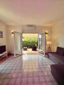 a living room with a couch and sliding glass doors at Casa Porto Palo in Porto Palo