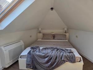 a bedroom with a bed with a blanket on it at Bel Composto Apartments in Perast