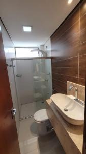 a bathroom with a toilet and a sink and a shower at Cantinho do Caribe Paraibano in João Pessoa +4 photos