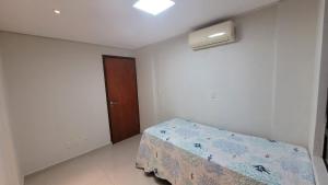 a bedroom with a bed and a window and a door at Cantinho do Caribe Paraibano in João Pessoa