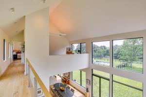 an open living room with large windows at Pool and Private Acreage Luxe Hudson Valley Home in Pine Plains