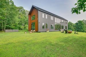 a large building with a grassy yard in front of it at Pool and Private Acreage Luxe Hudson Valley Home in Pine Plains