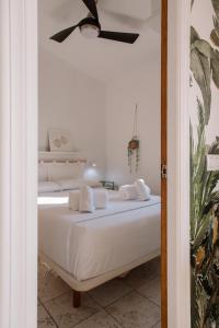 a bedroom with a bed with white sheets and towels at Antic Rooms Filador in Villajoyosa