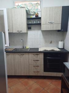 a kitchen with a sink and a stove at Portico Ratti in Riva Ligure +5 photos