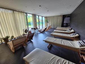 a room with several beds and chairs and windows at Skyline LuxurySPA in Wrocław