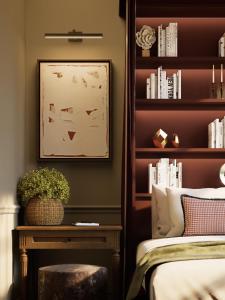 a bedroom with a bed and a book shelf at Cambridge Common House in Cambridge
