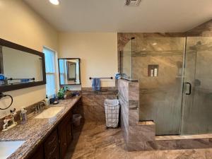 a bathroom with a shower and a sink at Historic Farmhouse on Hogan Ave in Reedley +49 photos