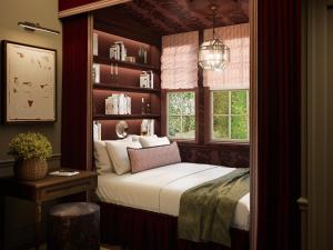 a bedroom with a bed and a book shelf at Cambridge Common House in Cambridge