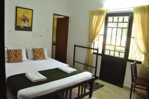 Postel nebo postele na pokoji v ubytování Lazar Residency Homestay