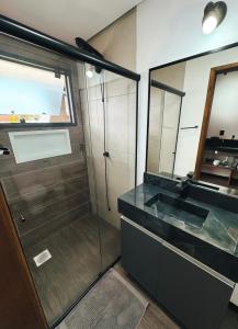 a bathroom with a sink and a mirror at Mentawai Lofts Praia do Rosa in Imbituba
