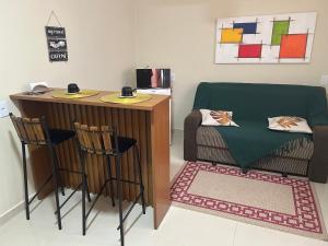 a room with a desk and a table and chairs at Chalé 4 vista para montanha in Penedo
