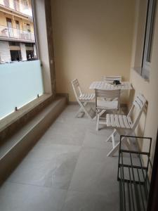 a room with a table and chairs and a window at Residenza Milla in Alassio