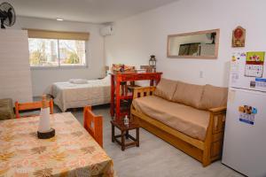 a living room with a couch and a refrigerator at Asturiano 6 Miramar in Miramar