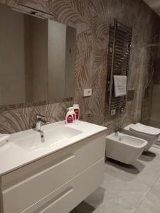 a bathroom with a sink and a toilet at Residenza Milla in Alassio +19 photos