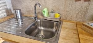 a kitchen sink with a faucet and utensils at Airam Campanario in Almansa +45 photos