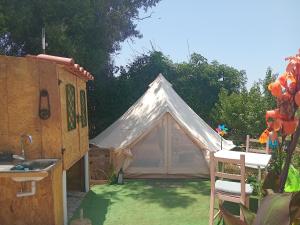 a tent in a yard next to a house at Casa dos Sonhos Glamping in Lagoa +34 photos