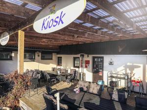 a room with chairs and a kush sign on the wall at 3 person holiday park home in Gørlev in Gørlev +9 photos