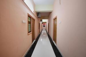 an empty hallway with black and white tiles on the floor at Super Hotel O Vellore New Bus Station Formerly SP Highway Inn in Vellore