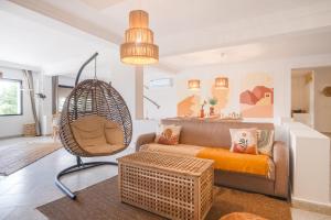 a living room with a couch and a chair at Luxurious 8-person Apartment in Tanger City Center in Tangier