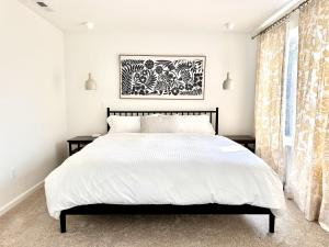 a bedroom with a large bed with white sheets at LeWeber Haus home in Leavenworth