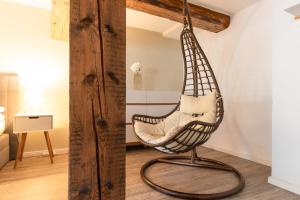 a swing chair hanging from a beam in a room at Ferienwohnung am Stadtschloss in Quedlinburg