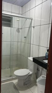 a bathroom with a toilet and a shower and a sink at Pousada Ribeiro 2 in Belém