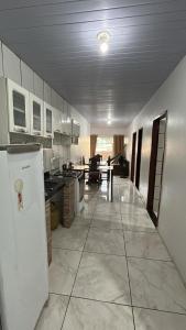 a large kitchen with a refrigerator and a table at Pousada Ribeiro 2 in Belém