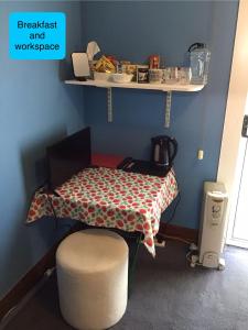 a table and a chair in a room at Strawberry fields in Devonport