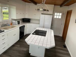 a kitchen with white appliances and a white counter top at A-town MSM Charmer in Anacortes +9 photos