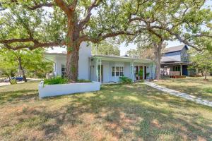 a white house with a tree in the yard at Walk to Mueller Lake Park! Home with Patio and Yard in Austin