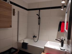 a bathroom with a sink and a bath tub at Ferienwohnung Vogelnest mit weitem Blick über den Schwarzwald in Baiersbronn