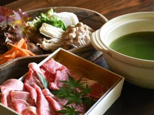a tray of food with a bowl of soup and vegetables at Kurokawa Mori No Kiki in Minamioguni