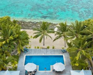 an aerial view of a resort with a swimming pool and the beach at Mokusiga Villas in Tangangge