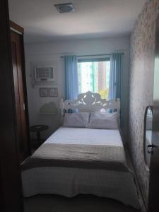 a bedroom with a large bed with a window at Rent in the Heart of COP 30 Belém in Belém +5 photos