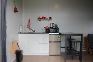 a kitchen with a counter with a microwave and a table at Night Sky Magic in Olive Grove in Gladstone