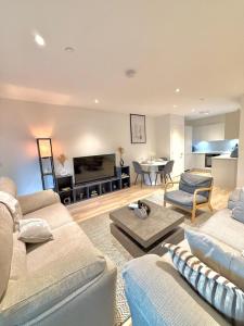 a living room with two couches and a table at Quiet Hideaway in London