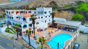an aerial view of a house with a swimming pool at HOTEL CHORRILLOS BEACH in Barranca