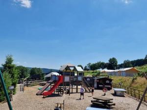 a park with a playground with a slide at Camping tent with modern amenities in Trois-Ponts