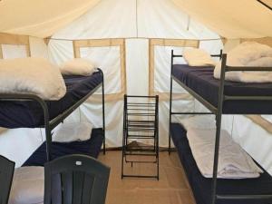 a room with three bunk beds in a tent at Camping tent with modern amenities in Trois-Ponts +15 photos