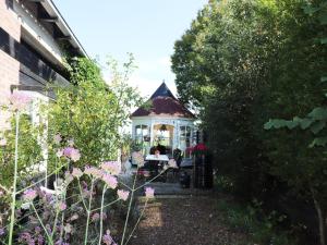 a gazebo in the middle of a garden at Beautifully styled apartment in Engelum