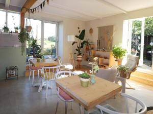 a living room with tables and chairs and windows at Beautifully styled apartment in Engelum
