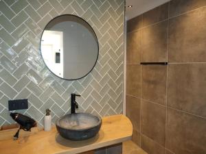 a bathroom with a sink and a mirror on a counter at Beautifully styled apartment in Engelum +20 photos